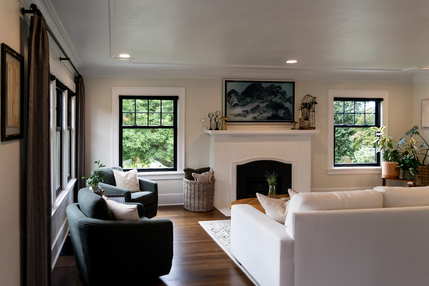 A living room with Renewal by Andersen black double hung windows