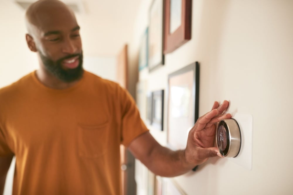 Man fixing the thermostat