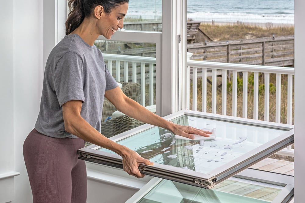 Woman cleaning window
