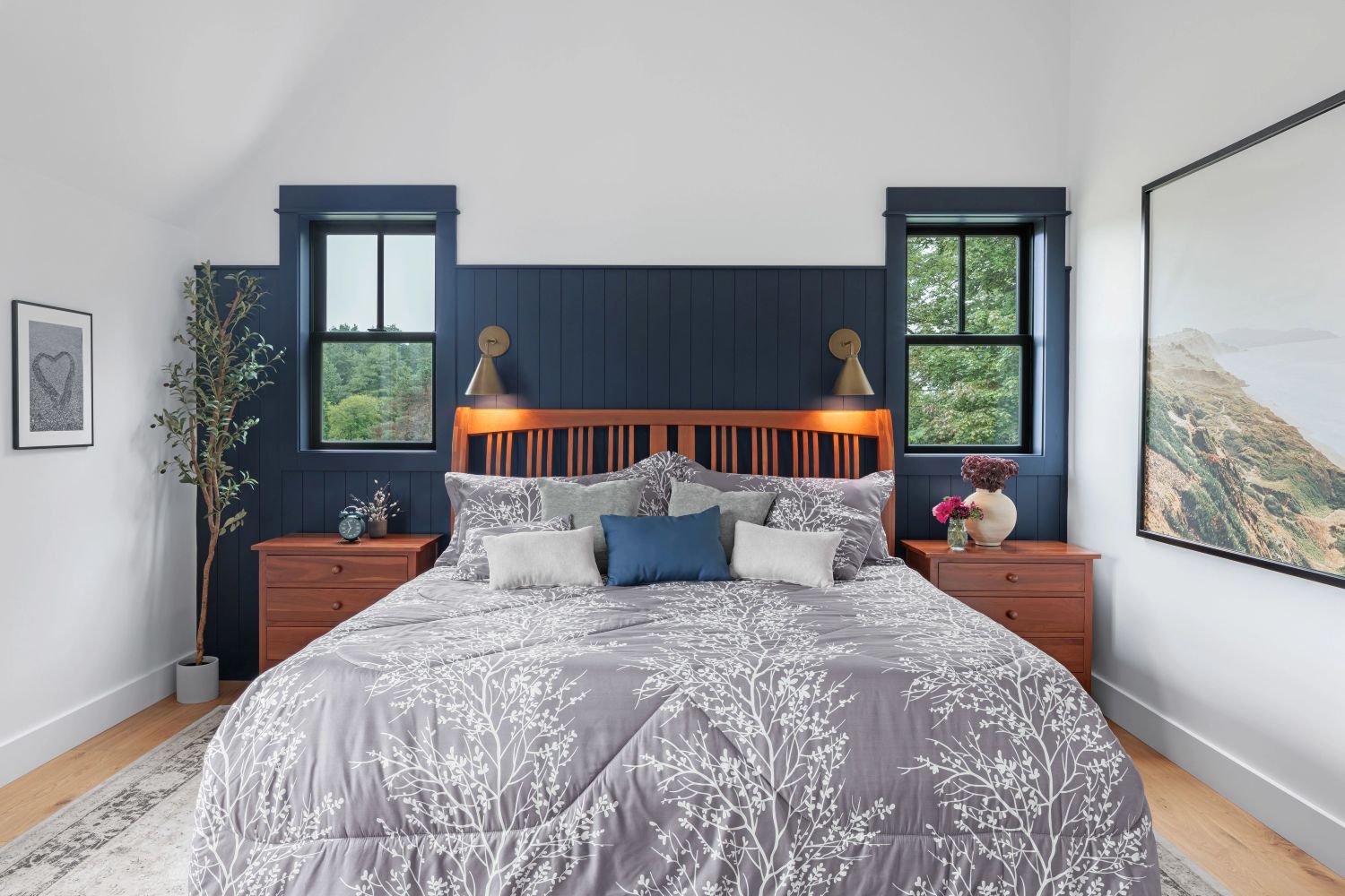 A bedroom with two double hung windows on each side