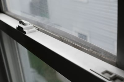 Close up image of a warped vinyl window