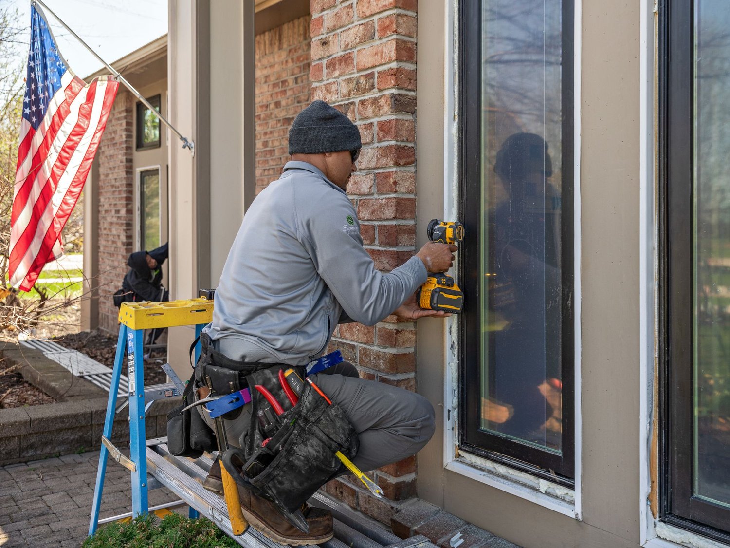 Installer looking at renewal by ANdersen Window