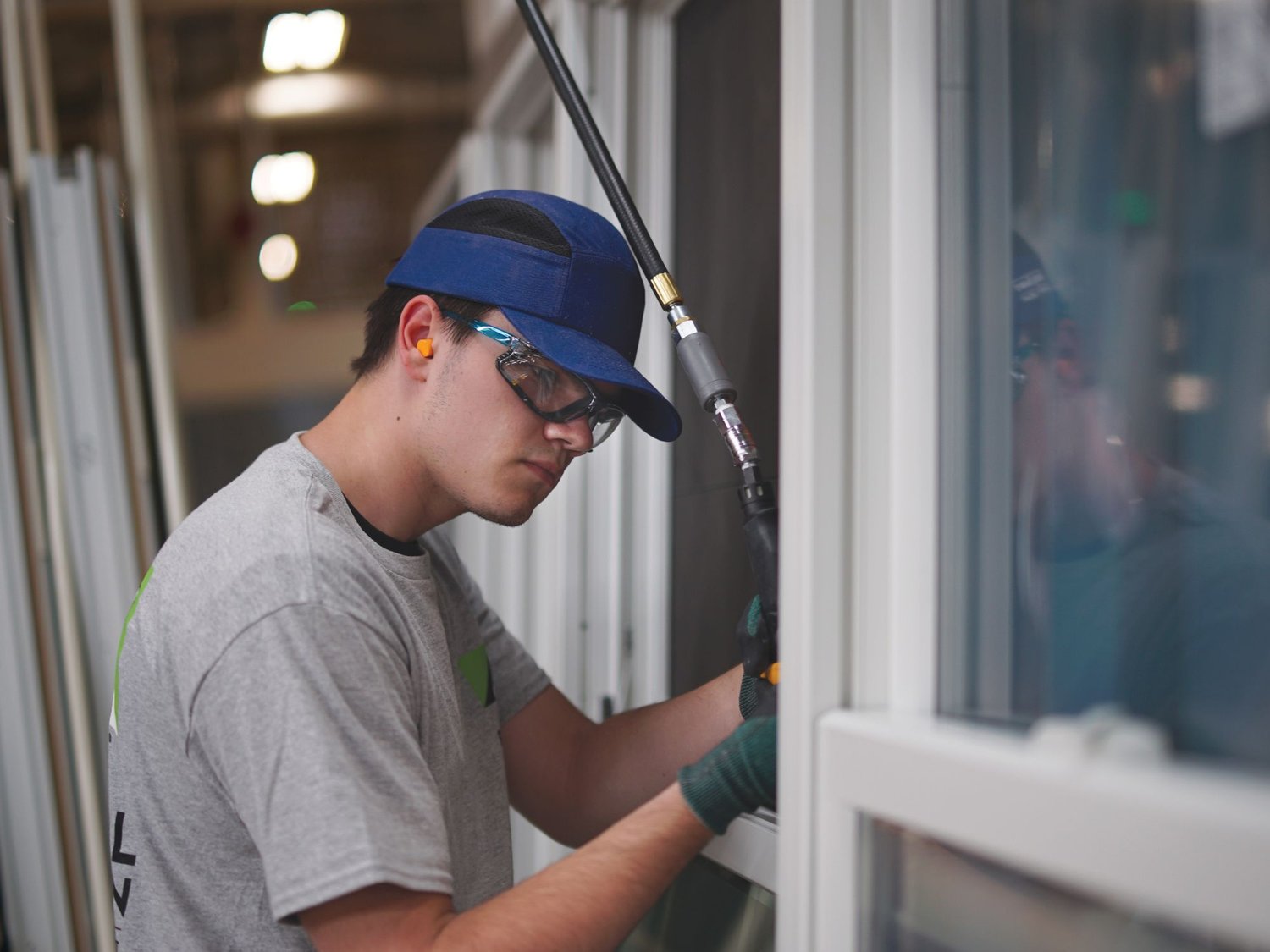 Renewal by Andersen installer checking the windows