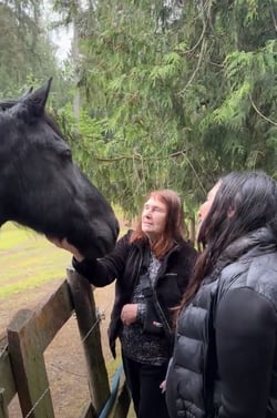 Two women petting a horse at Equine Rescue Center.
