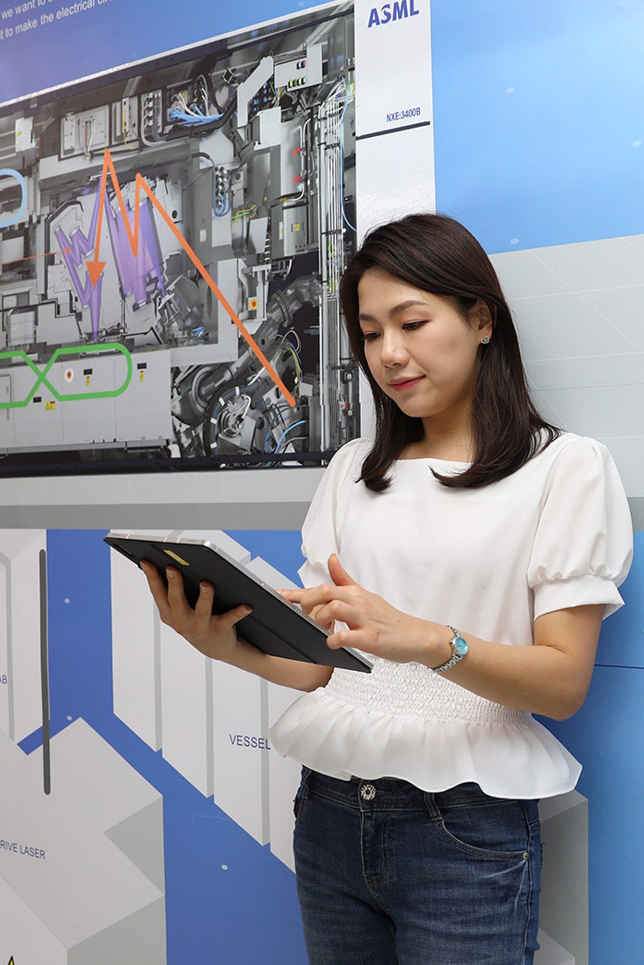 ASML employee in South Korea looks at her tablet