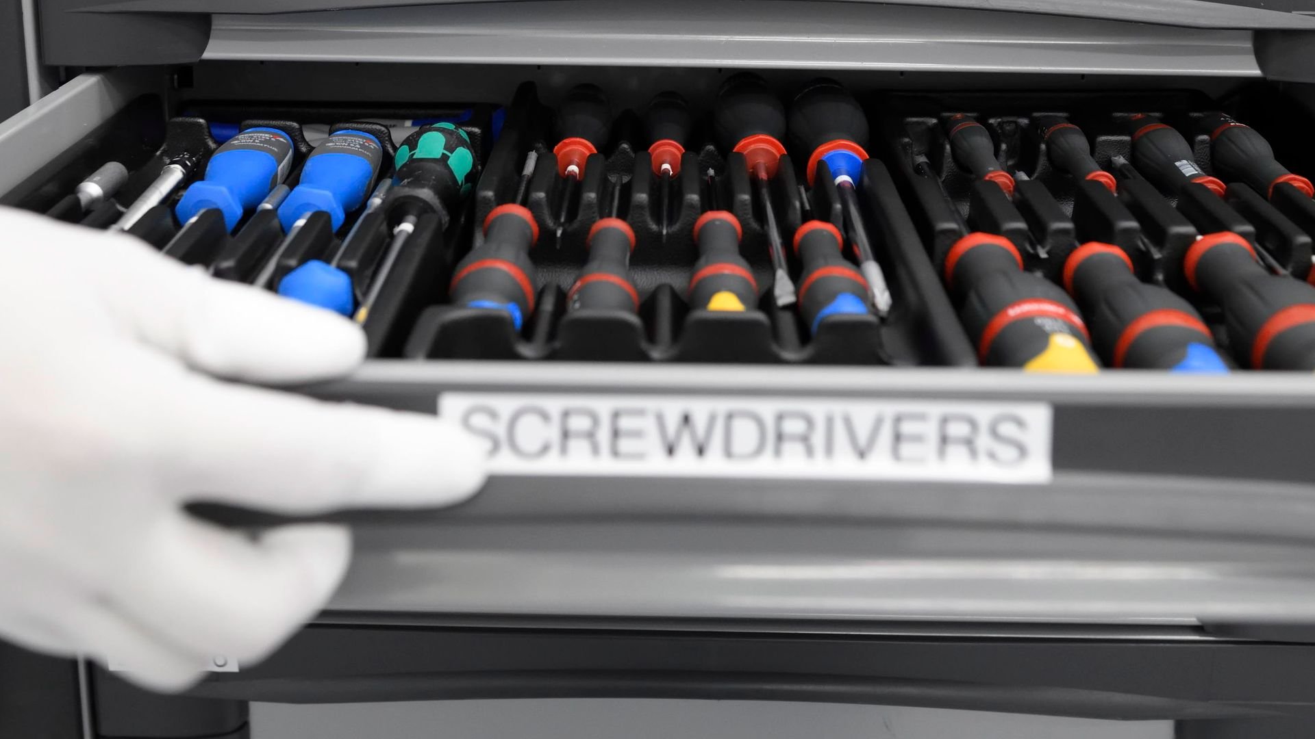 hand opening drawer of screwdrivers