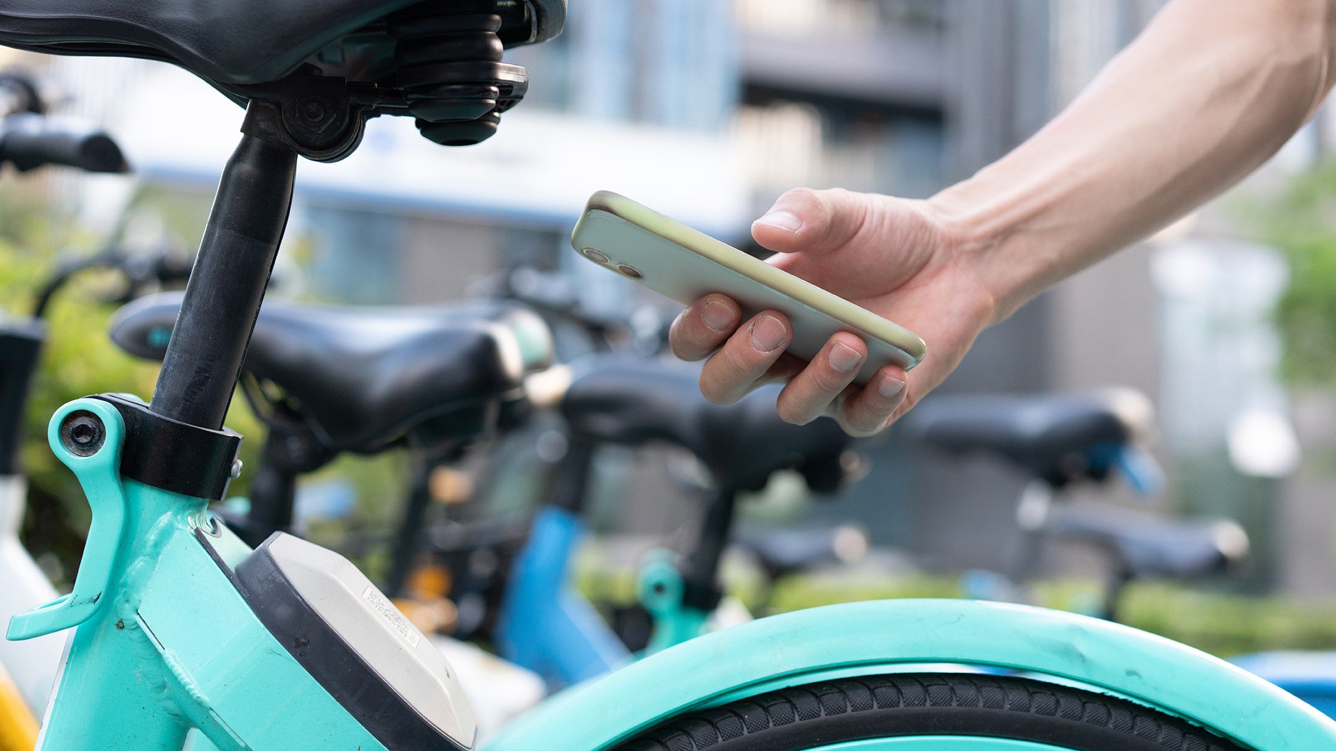 Person with a mobile phone renting a scooter