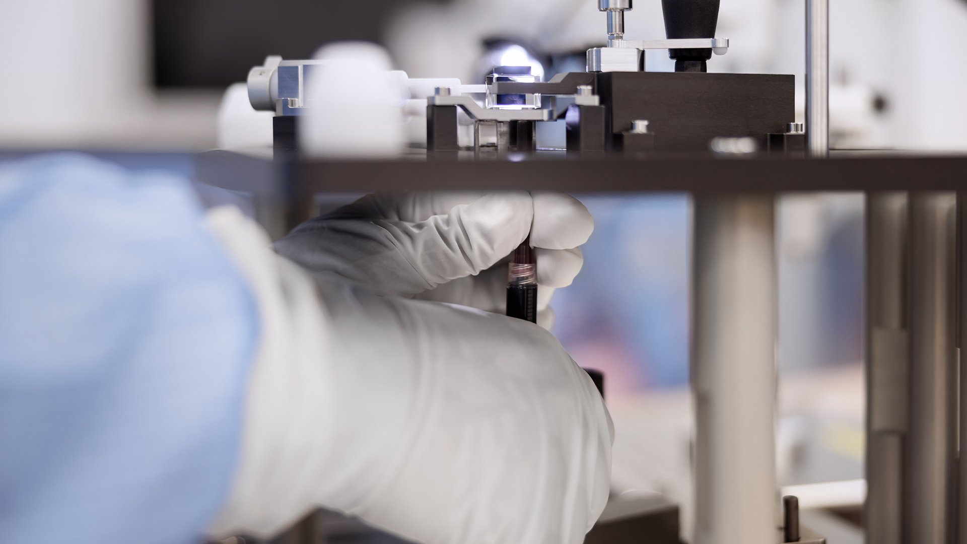 Technician adjusting precision equipment