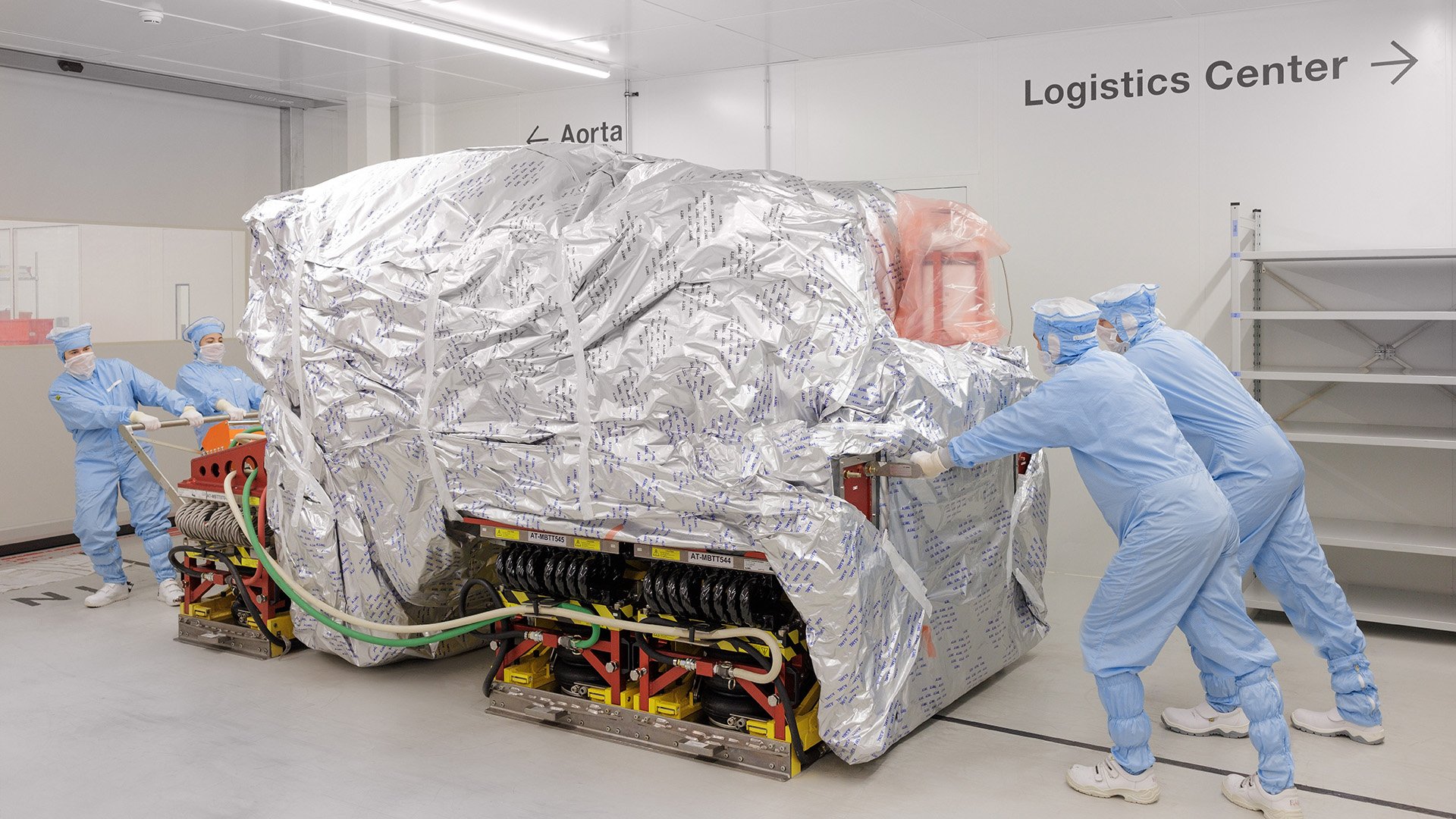 Technicians moving equipment in a cleanroom 