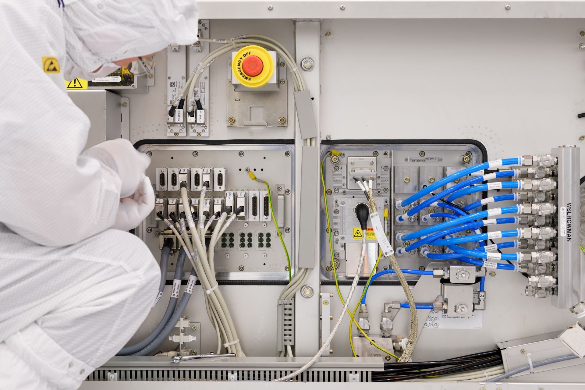 ASML technician working on a machine component ASML technician working on a machine component