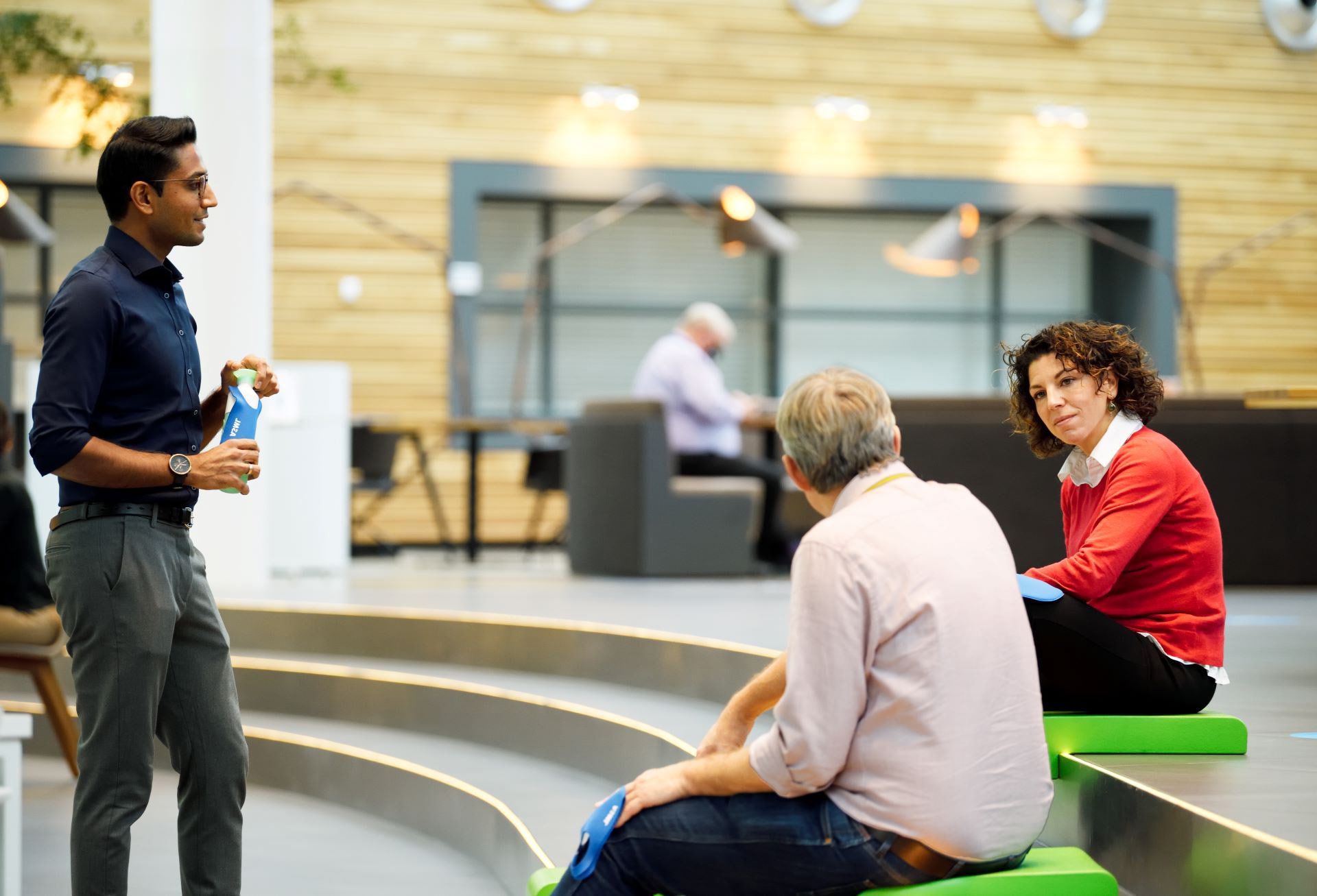 ASML employees talking together at our plaza ASML employees talking together at our plaza