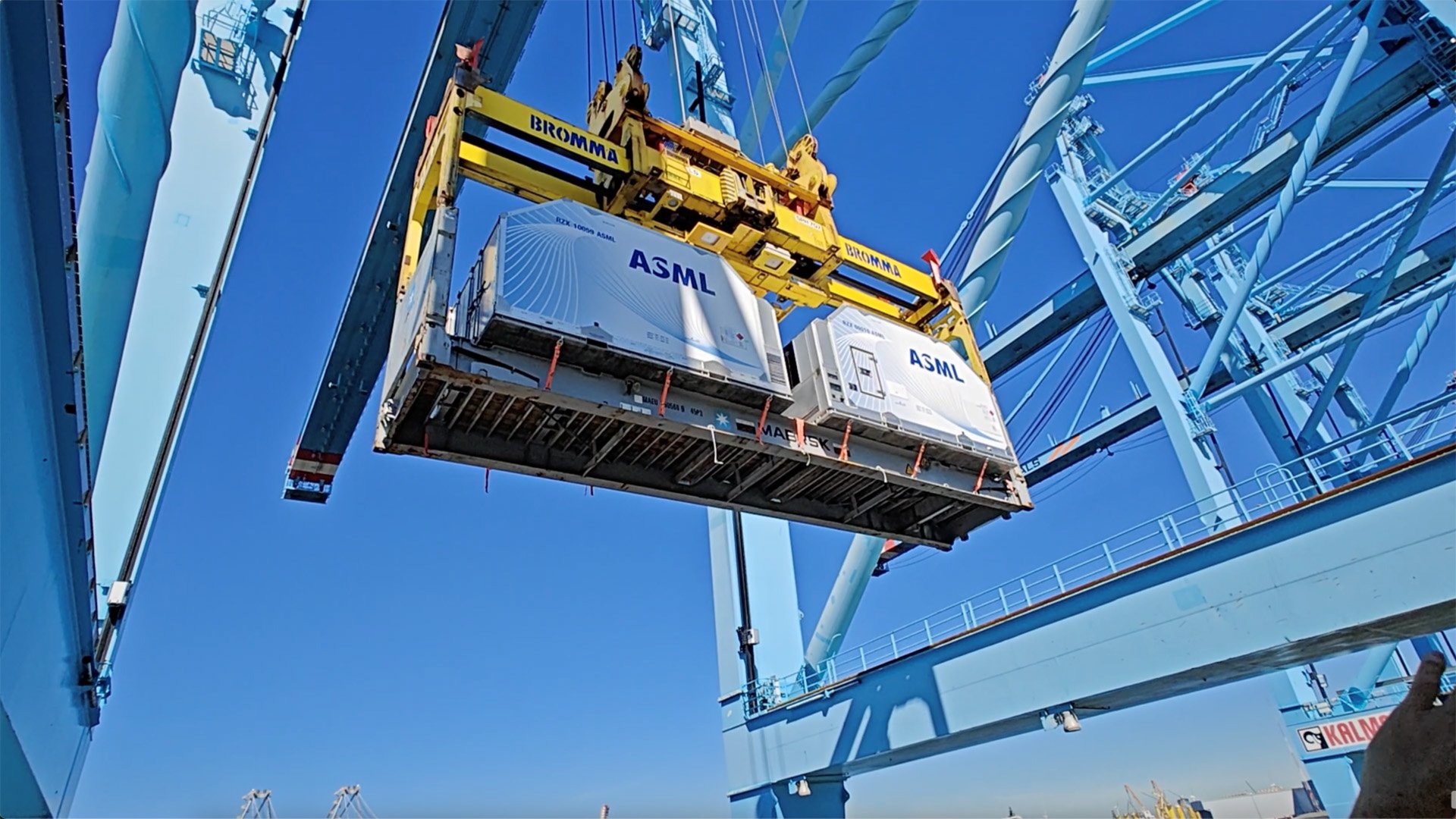 ASML equipment being lifted by a crane at an industrial site ASML equipment being lifted by a crane at an industrial site