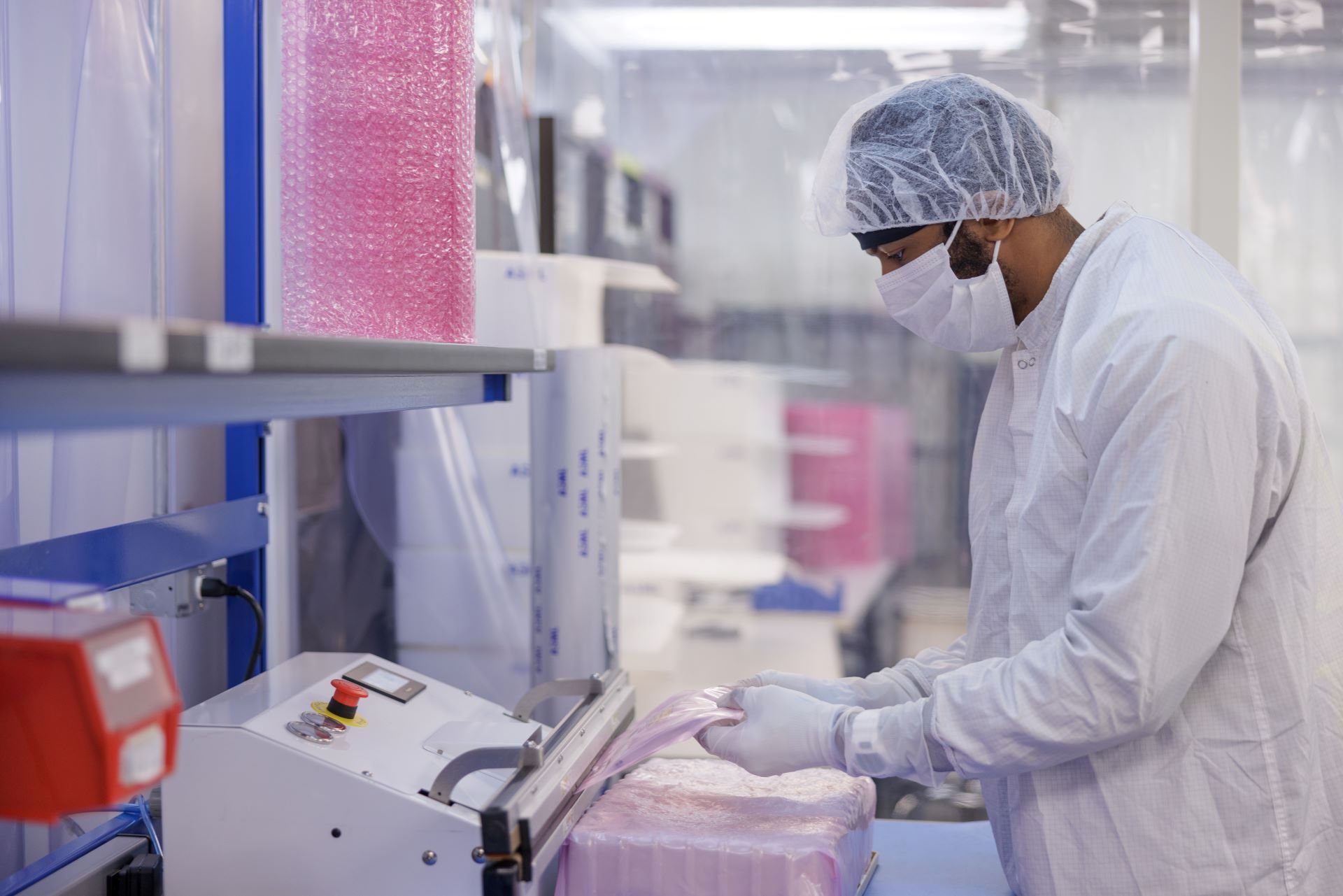Technician operating equipment in a cleanroom Technician operating equipment in a cleanroom