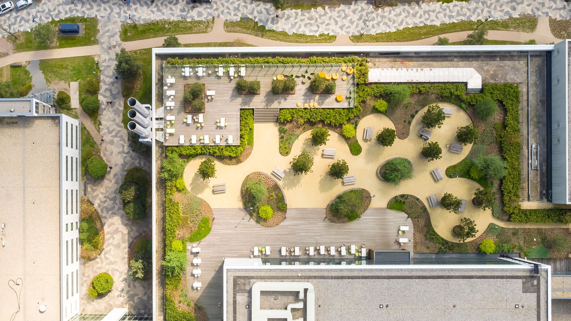 drone shot of ASML campus with paths and trees