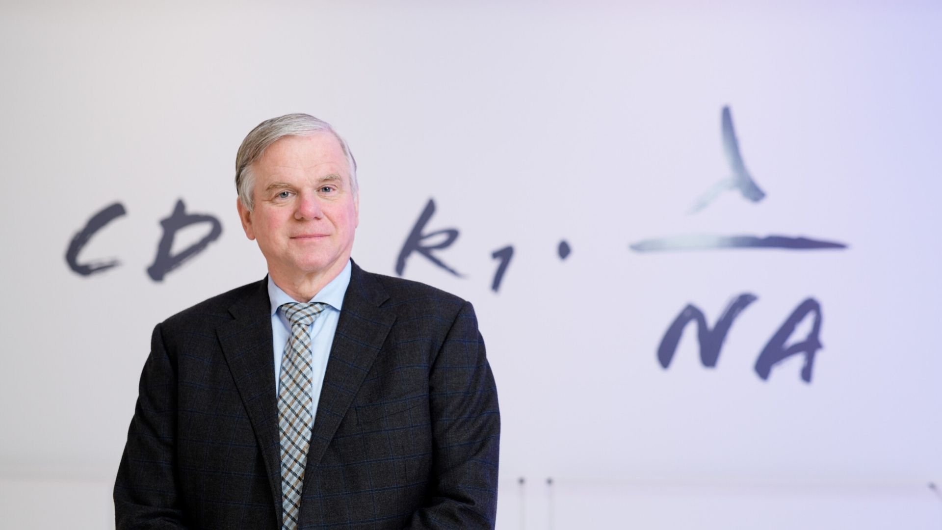 ASML CTO Martin van den Brink stands in front of the Rayleigh criterion equation in the ASML Experience Center in Veldhoven, the Netherlands.