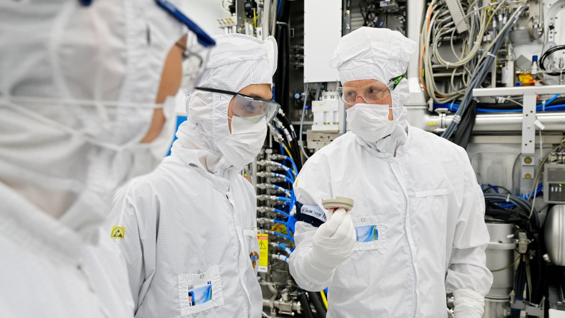 Technicians discuss inside ASML's EUV factory cleanroom in Veldhoven, the Netherlands