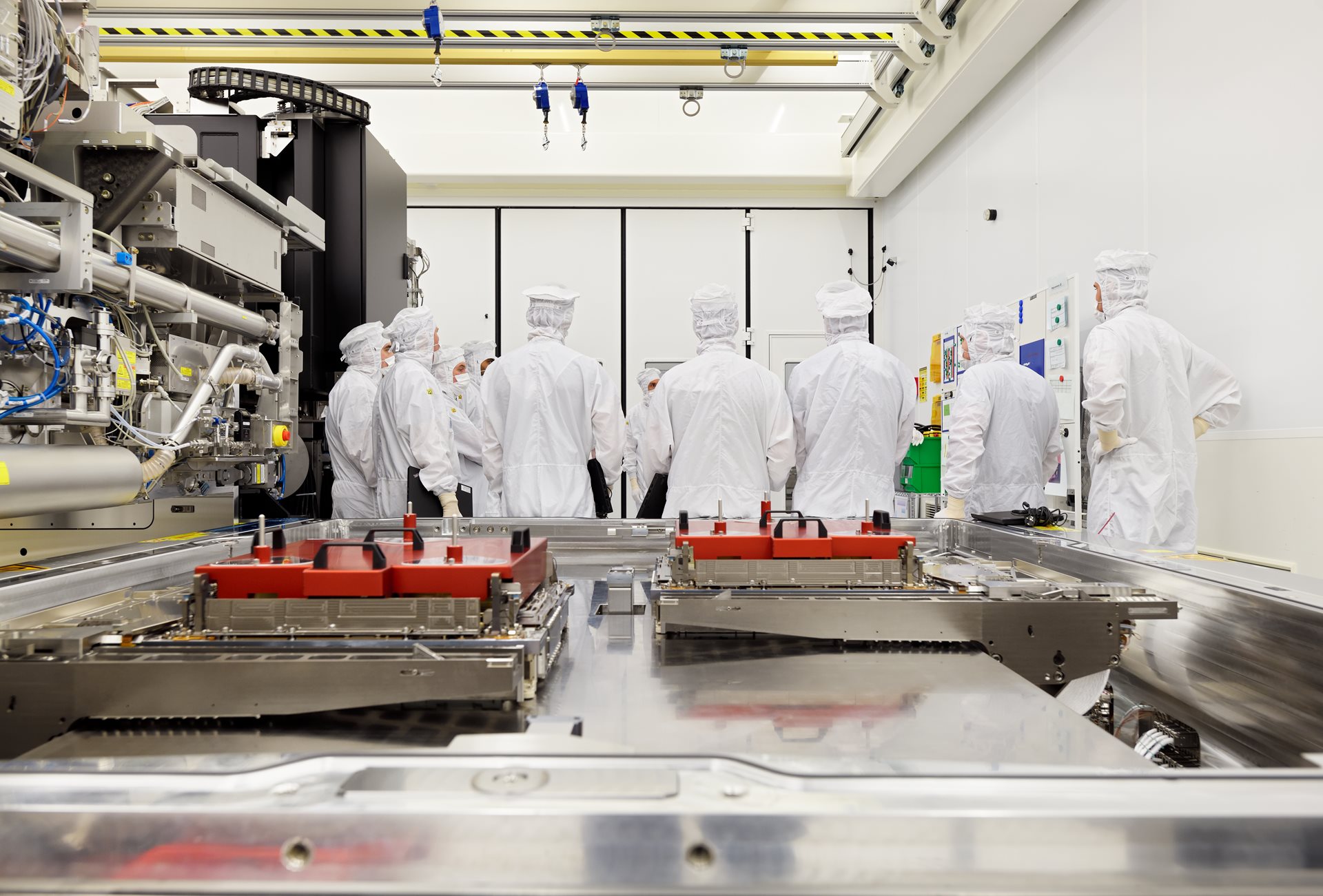 ASML engineers work on EUV system, overlooking a wafer table. 