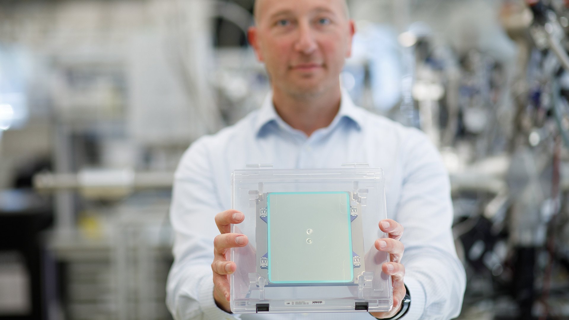 ASML system engineer Guido Salmaso holds an ASML EUV pellicle inside a laboratory at ASML in Veldhoven, the Netherlands.