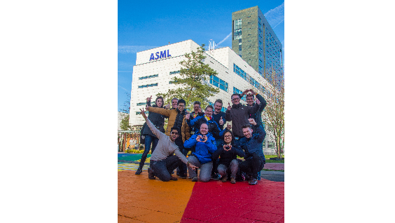 A group of ASML employees from Proud, the LGBTI employee network, pose on the rainbow crossing. 