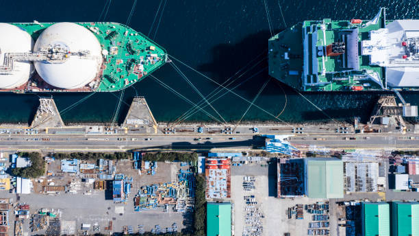 Two large ships are anchored at a port for loading and unloading supplies Two large ships are anchored at a port for loading and unloading supplies