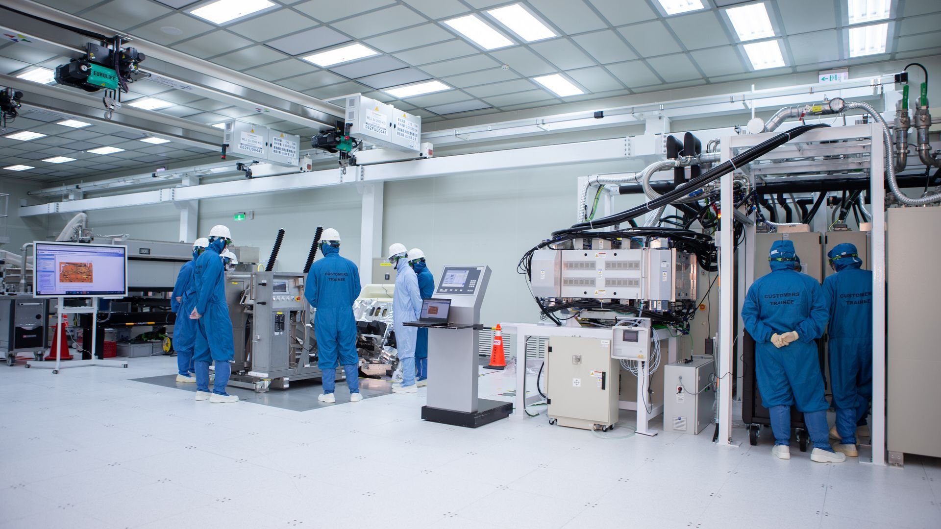 employees in cleanroom suits working in cleanroom