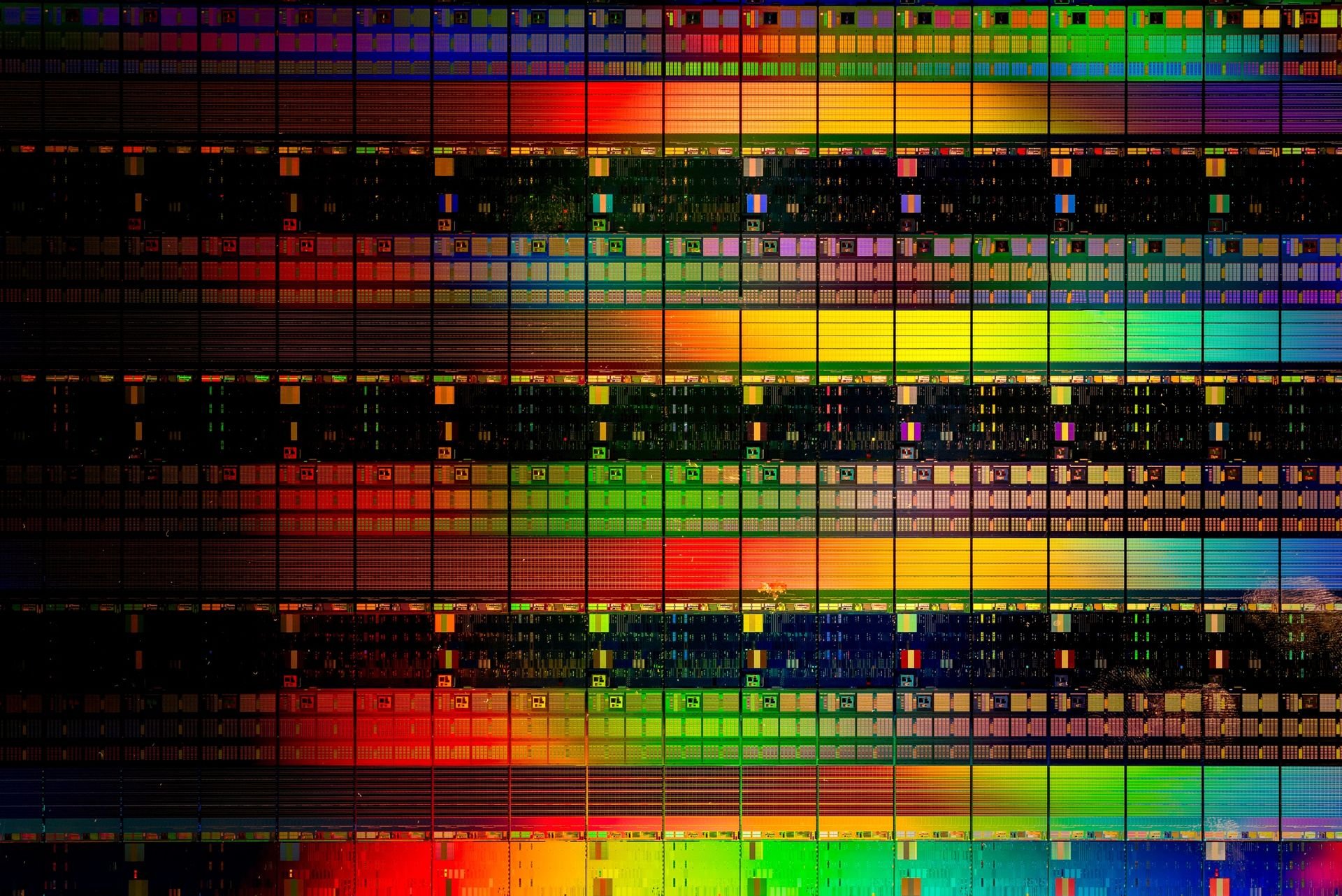 A closeup of a silicon wafer containing colorful chips