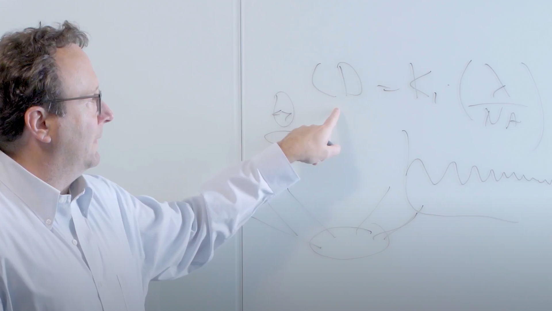 ASML researcher Scott Middlebrooks explains the Rayleigh criterion in a whiteboard session.