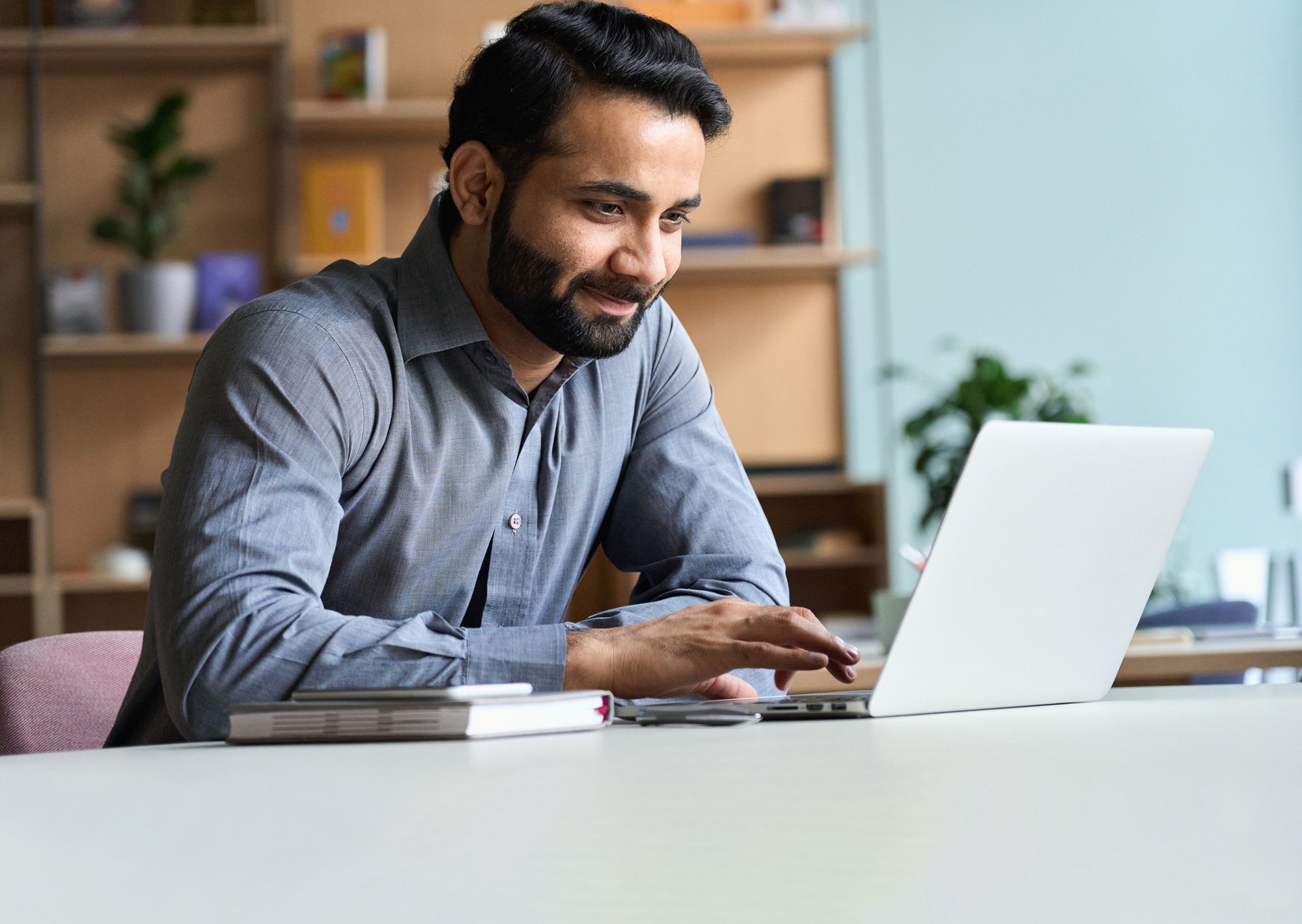Man sitting at table with laptop on table