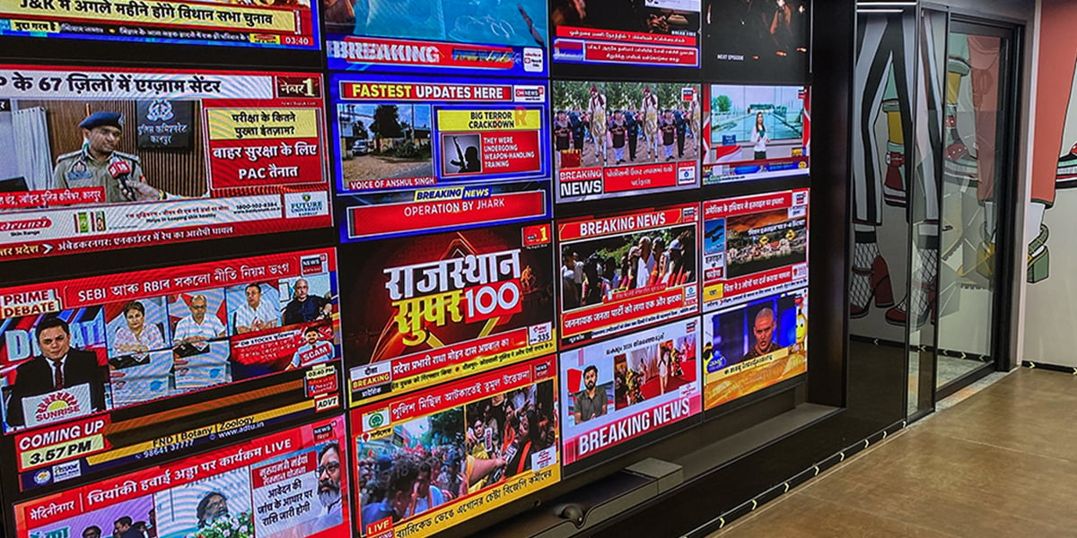 TV screens with Indian news on