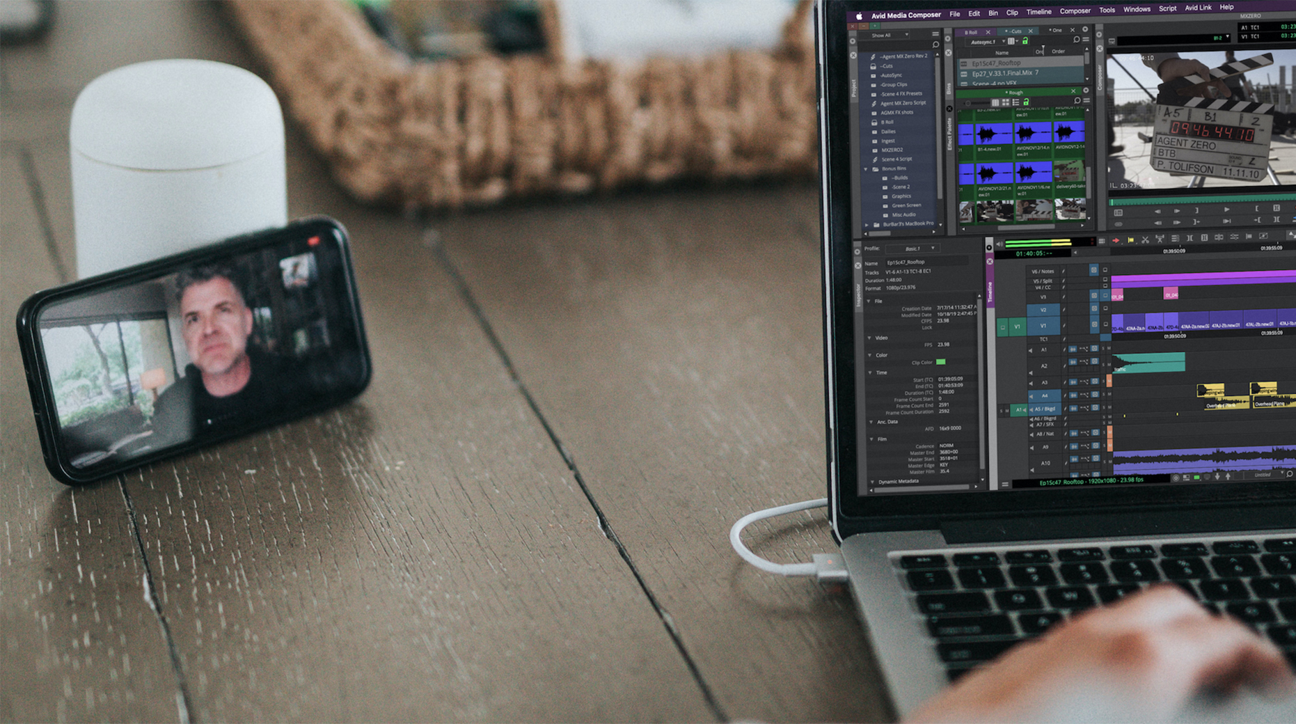 A film editor works remotely while collaborating with a colleague on a video call.