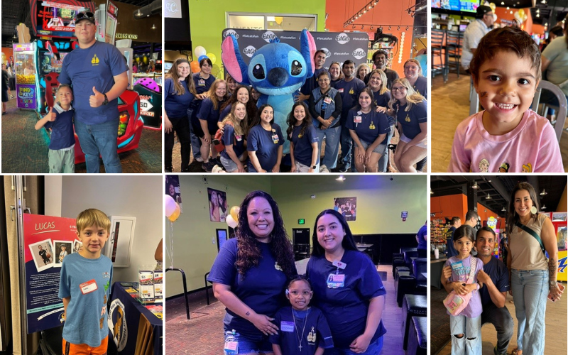 A group of people in blue shirts stand around a large Stitch mascot costume at an event.