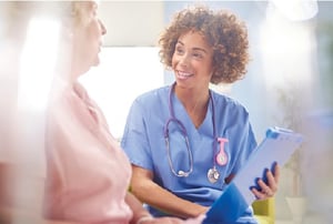 African-American female healthcare worker consulting with patient. 