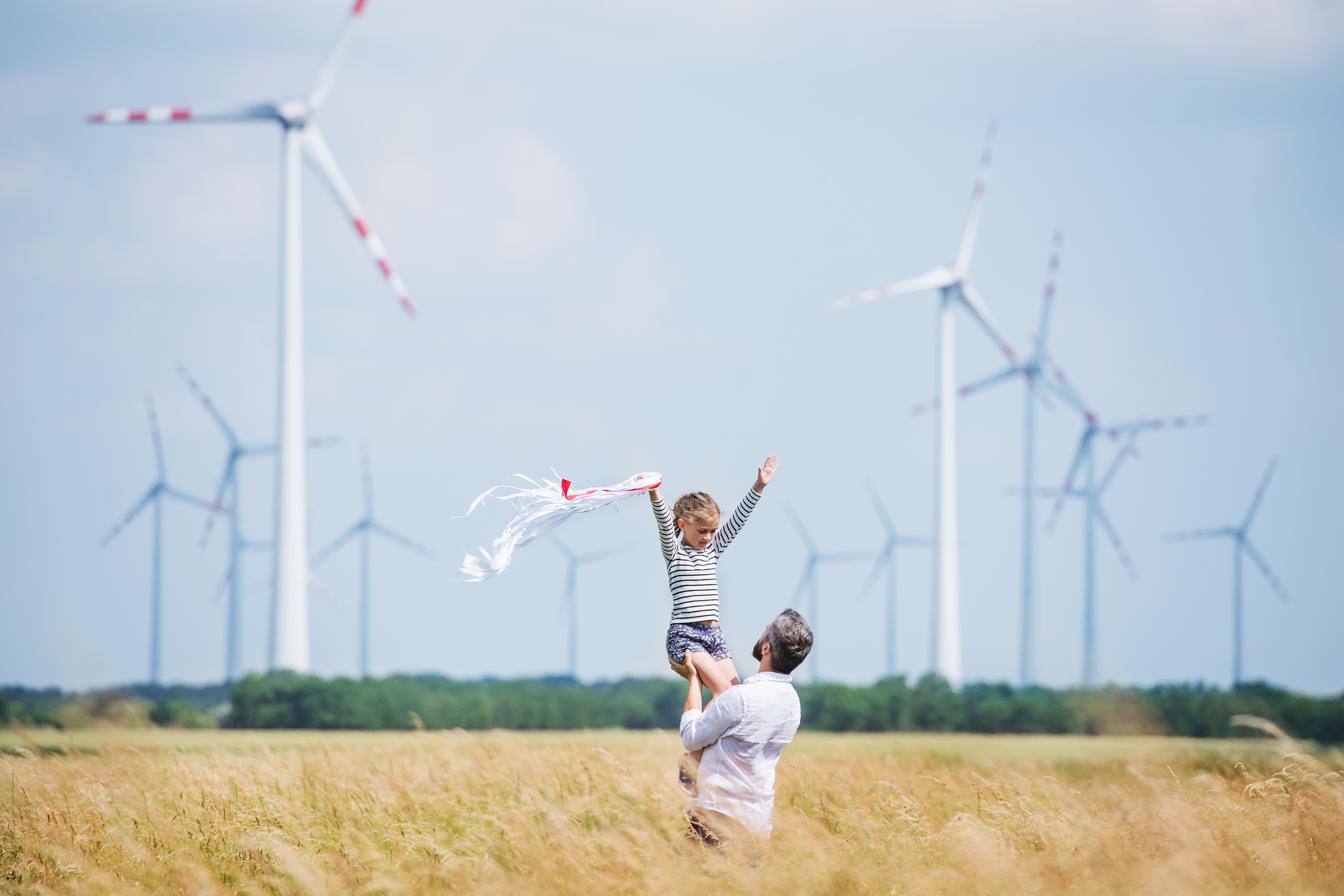 father_and_daughter_in_front_of_wind_farm