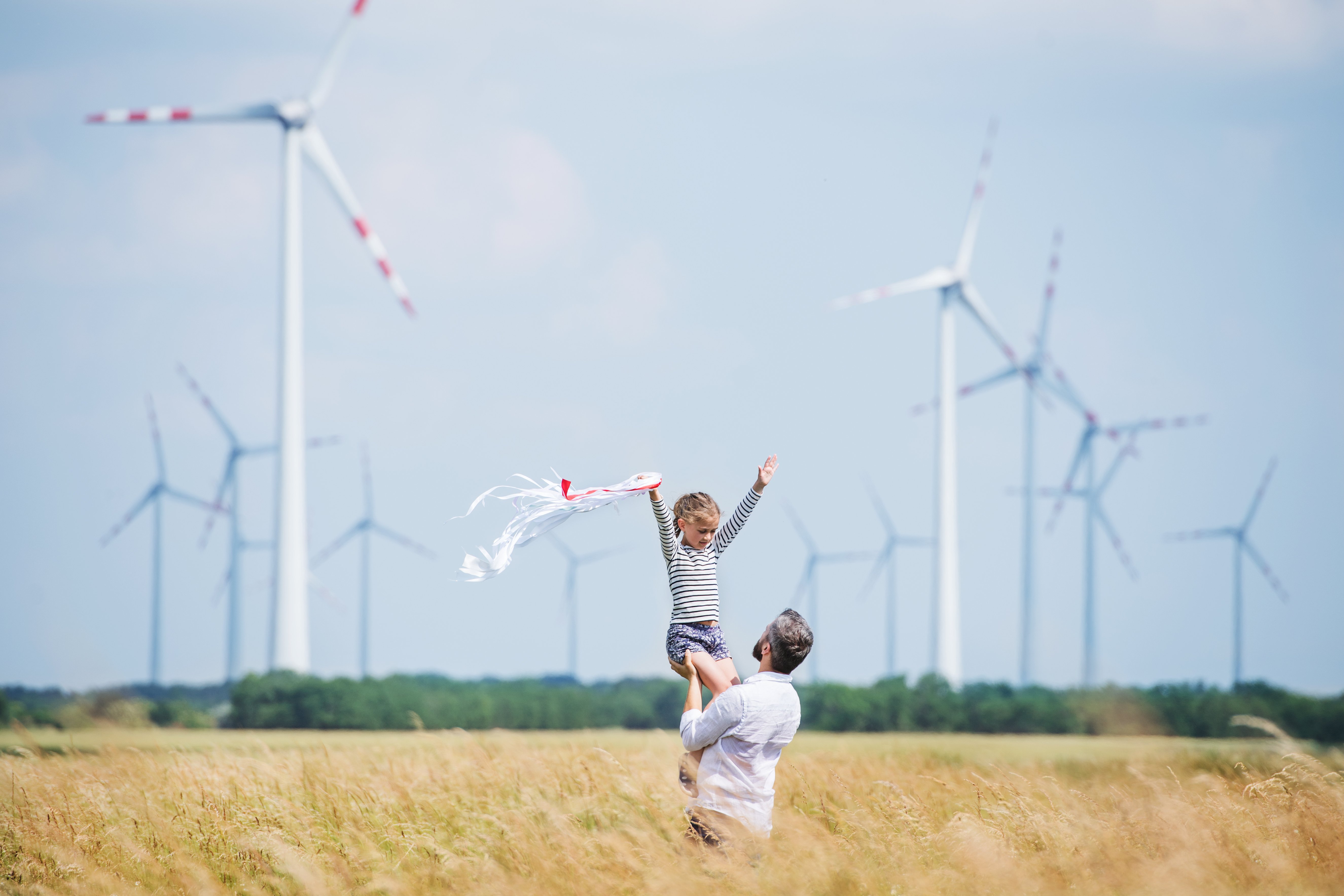 father_and_daughter_in_front_of_wind_farm