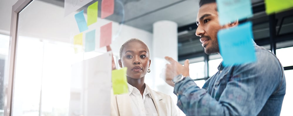 Two people looking at notes
