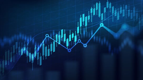 Blue-toned financial chart with rising candlestick patterns and a line graph indicating upward market trends.