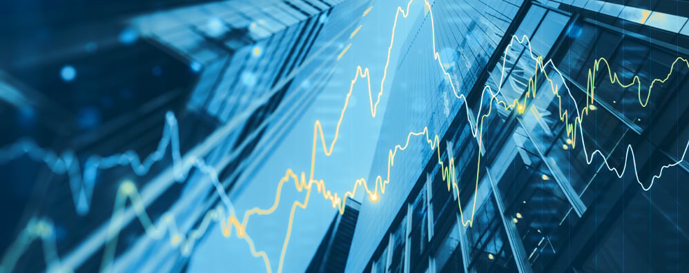 Modern skyscraper facades with financial graphs in blue and yellow, conveying a theme of dynamic economic activity.