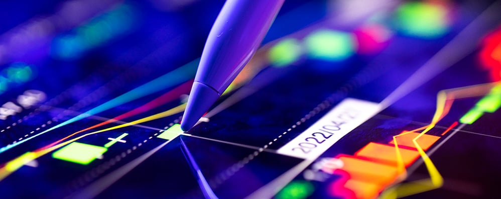 A screen pen touching a screen with colorful bar graphs, graphs, and visuals.