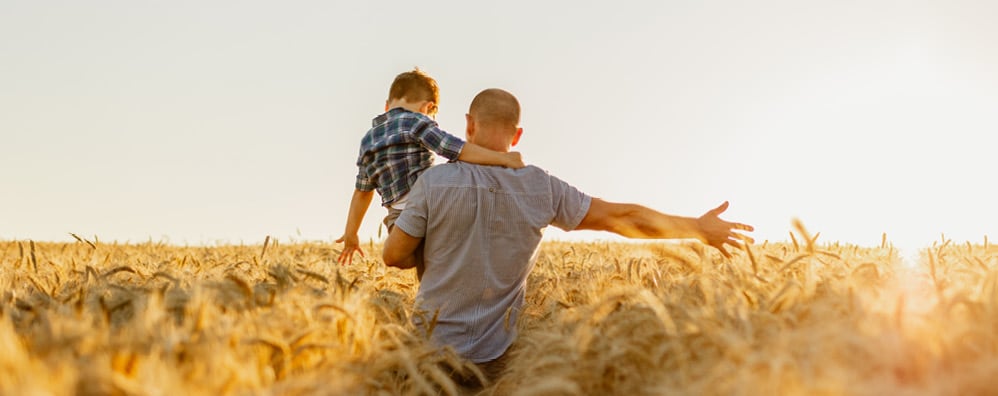 Man and child in a field