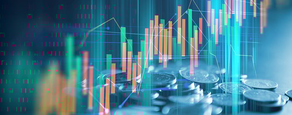 Stacks of coins overlap with a digital stock market chart, featuring colorful upward and downward bars.