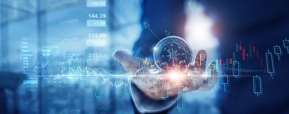 A hand holds a compass overlaid with digital stock charts and numbers.