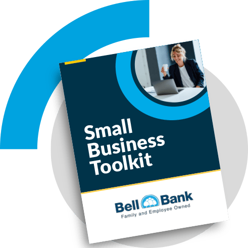 Small Business Toolkit with a women holding a coffee and smiling at computer