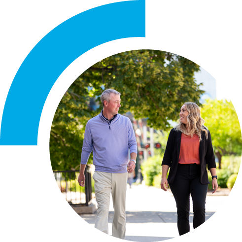 A man and woman walking and talking outside