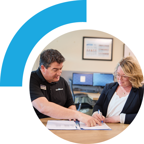 Bell employee working on paperwork with a customer.