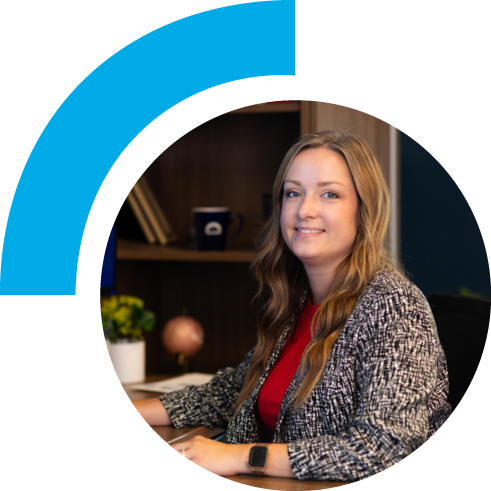 A woman working in an office setting smiling