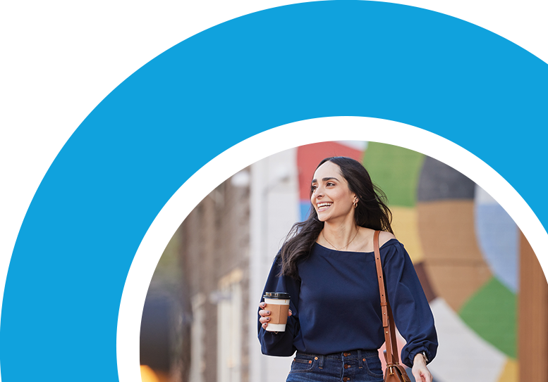 Woman holding coffee and walking