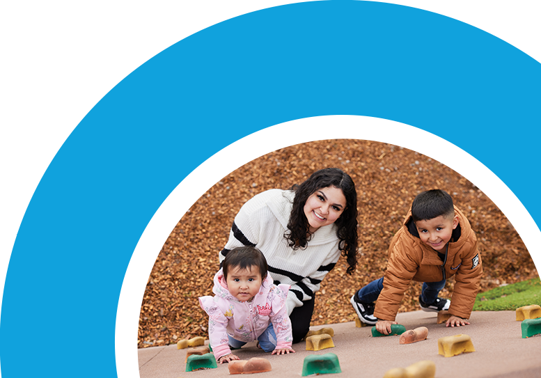 Family playing on playground smiling