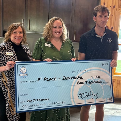 Pay It Forward Collegiate Individual Winner, Zach May holding check with staff members