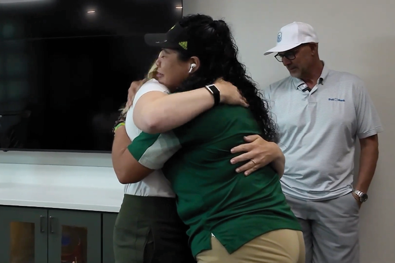 PIF College Winner, teammates hugging
