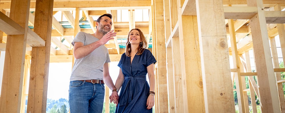 A couple walking through a new build home.